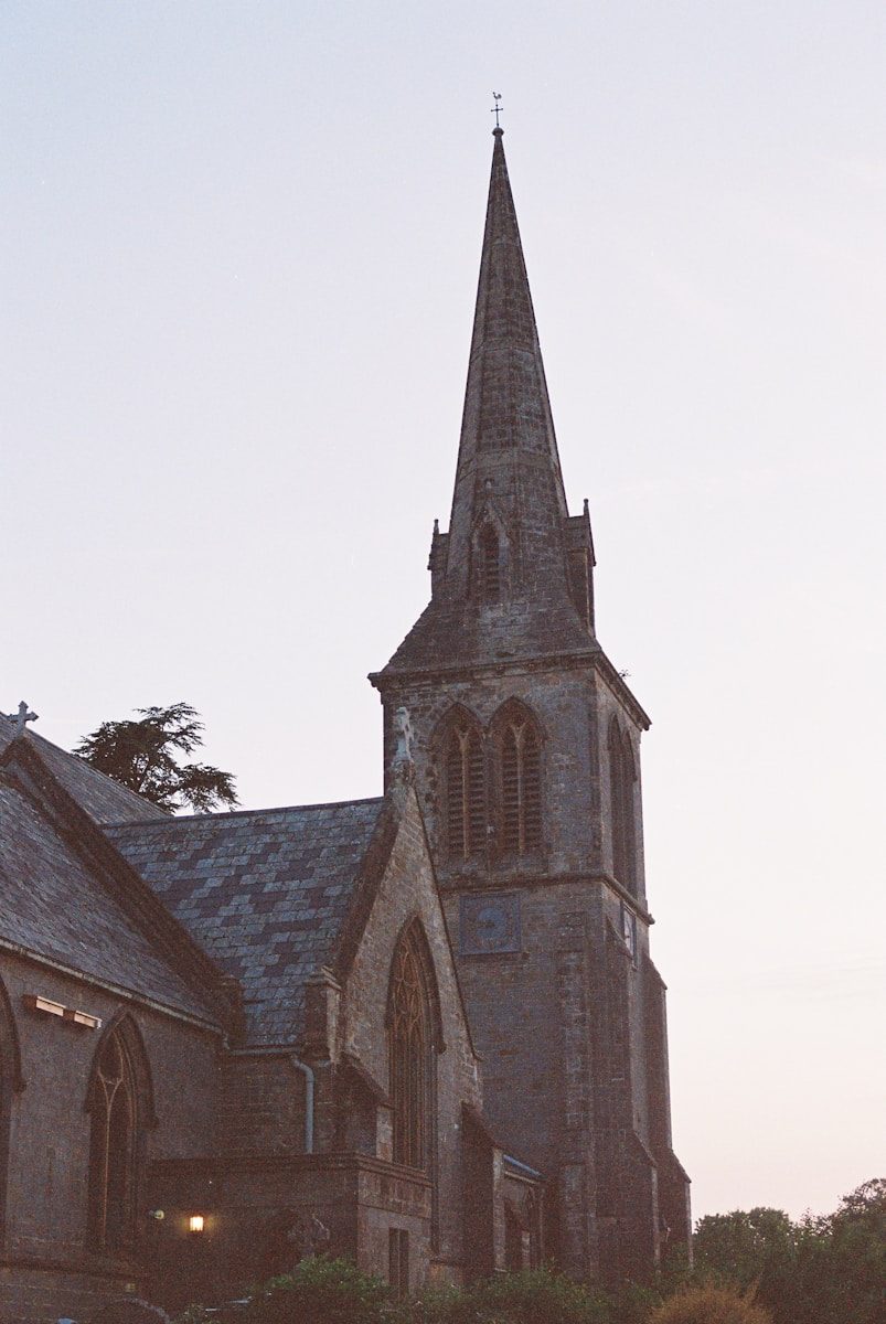 A tall church spire against a light sky.